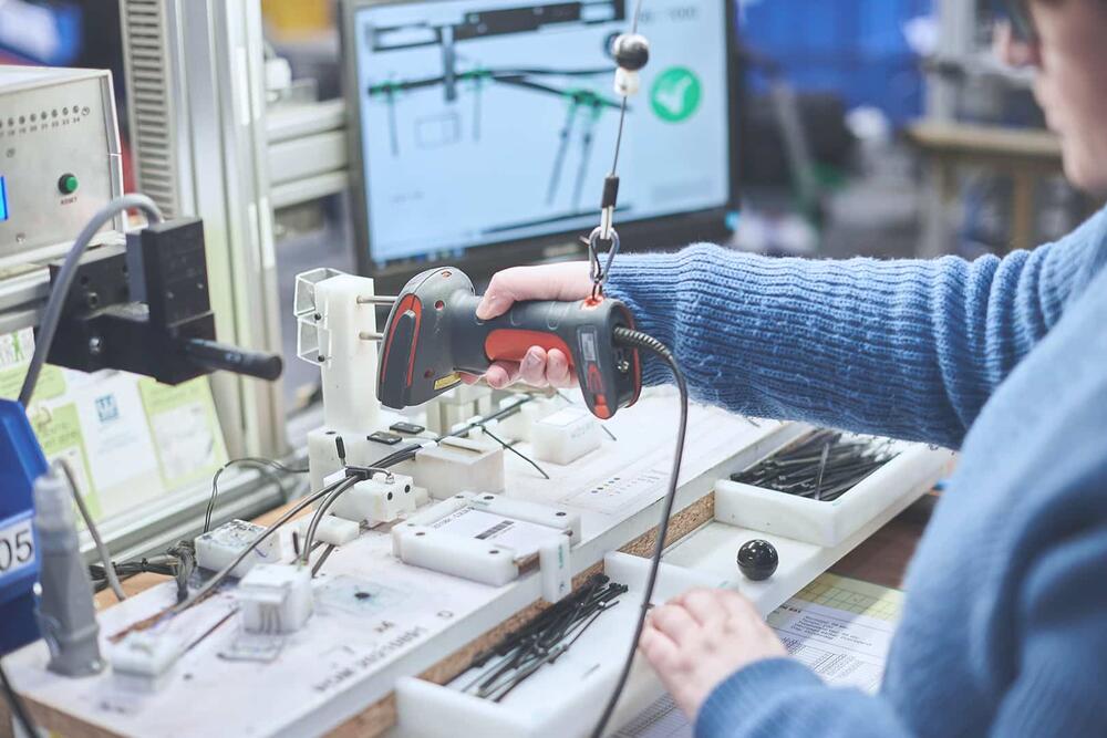 WAAK employee is assembling a cable harness